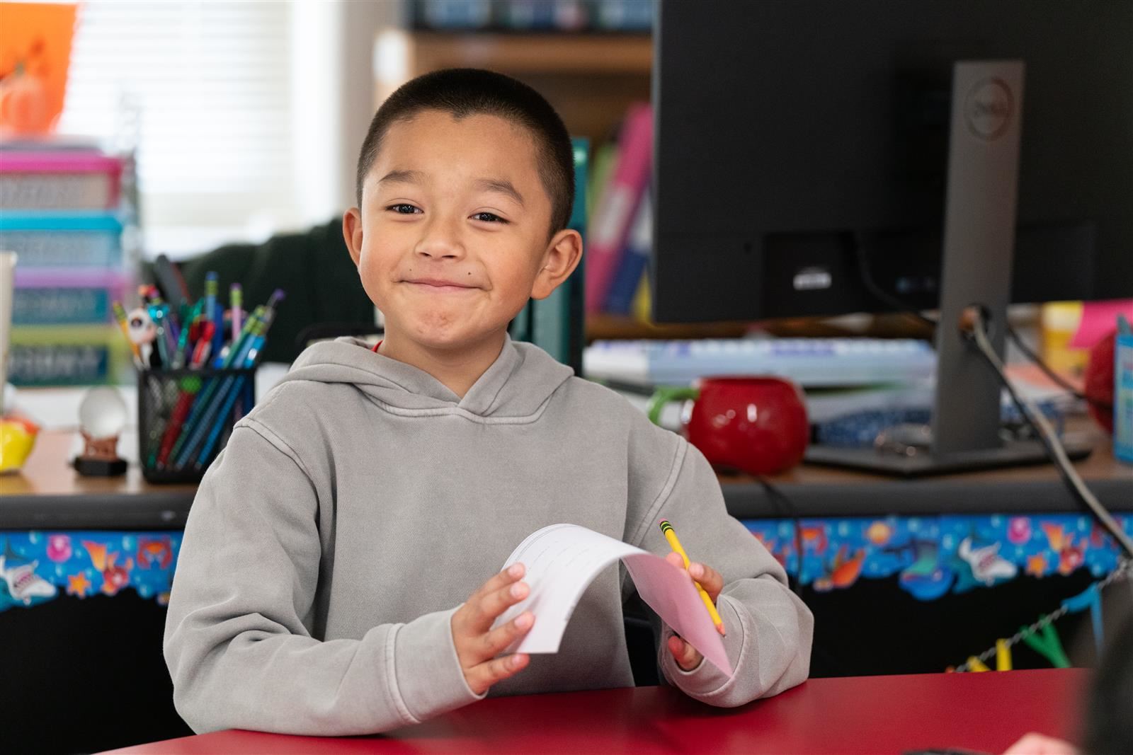 A child smiles at the camera