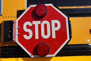A red STOP sign on a District U-46 school bus 